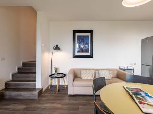 een woonkamer met een bank en een tafel bij Apartment Europa-1 by Interhome in Ledro
