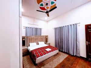 a bedroom with a bed with a red blanket at Stayble Homestay in Dehradun