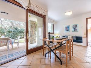 a dining room with a table and chairs and a couch at Holiday Home Carlo-2 by Interhome in Notteri