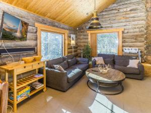 a living room with a couch and a table at Holiday Home Muuttohaukka by Interhome in Ruka