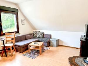 a living room with a couch and a table at Apartment Gebauer-2 by Interhome in Fuchshofen
