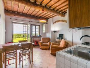 eine Küche und ein Wohnzimmer mit einem Tisch und Stühlen in der Unterkunft Apartment Casa Renai a San Gimignano-6 by Interhome in San Gimignano