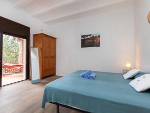 - une chambre avec un lit bleu et une fenêtre dans l'établissement Apartment Mas Mato Down by Interhome, à Begur