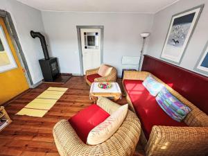 a living room with two couches and a table at Holiday Home Kapitänshaus Leo by Interhome in Leopoldshagen +14 photos