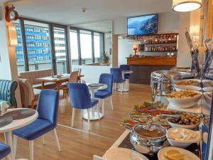 un restaurante con un buffet de comida en una mesa en APART-HOTEL ORBI CITY, en Batumi