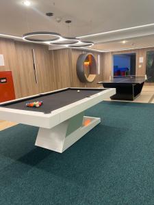 a gaming room with a pool table and a billiard at Hotel Firenze in Serra Negra