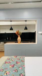a kitchen with a vase of flowers on a counter at Janki Kunj Varanasi- 3 Room Home in Varanasi +4 photos