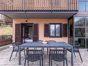 a blue table and chairs in front of a house at Apartment Superior-1 by Interhome in Mezzolago