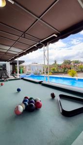 a pool table with balls on top of it at Eco Hotel Valley View in SJM