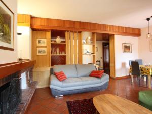 a living room with a couch and a fireplace at Apartment I Gerani by Interhome in Scanno +25 photos