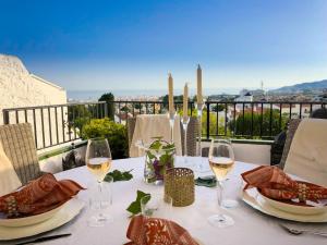 a table with glasses of white wine on a balcony at Apartment Limoneros by Interhome in Nerja