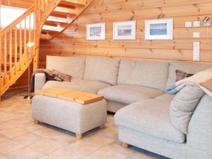 a living room with a couch and a table at Holiday Home Tahkontupa by Interhome in Tahkovuori