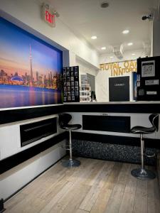 a barber shop with two stools and a large screen at Royal Oak Inn in Toronto