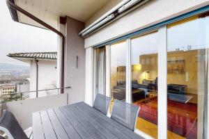 a balcony with a view of a living room at Bright 1 bedroom flat in the city centre (Greenyard 2) in Zurich