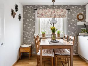 a dining room with a table and chairs and a window at Holiday Home Skjutsmåla - B in Olofström