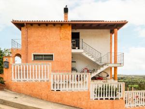 a house with a staircase and a balcony at Apartment Sea view by Interhome in Villaputzu