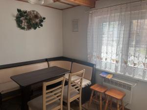 a small dining room with a table and two chairs at Penzión Pohoda in Zuberec
