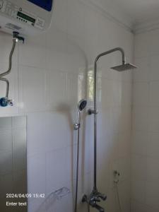 a shower with a glass door in a bathroom at A 4G LODGE in Mugumu