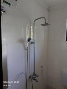 a shower with a glass door in a bathroom at A 4G LODGE in Mugumu