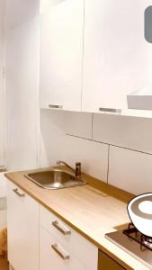 a kitchen with a sink and white cabinets at 5 bedrooms apartement at Napoli 500 m away from the beach with sea view and wifi in Naples