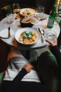 a person sitting at a table with a plate of food at TORTUE Hamburg in Hamburg