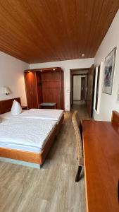 a bedroom with a large bed and a wooden ceiling at Hotel Hirschberg in Hirschberg an der Bergstraße