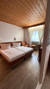 a bedroom with a large bed with a wooden ceiling at Hotel Hirschberg in Hirschberg an der Bergstraße