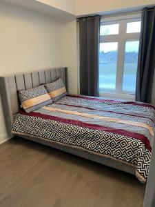 A bed or beds in a room at Bowmanville Room for rent