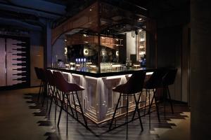 a bar in a room with chairs around it at TORTUE Hamburg in Hamburg