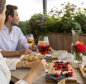 a couple sitting at a table with wine and food at TORTUE Hamburg in Hamburg