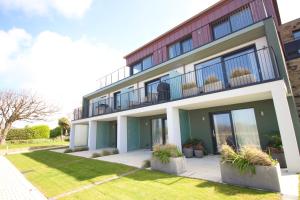 a building with plants in front of it at Coastal apartment sea views in Saint Merryn