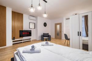 a bedroom with a large bed and a tv at Stylish Studio with Free Parking in Sofia