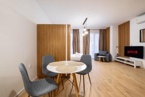 a living room with a table and chairs at Stylish Studio with Free Parking in Sofia