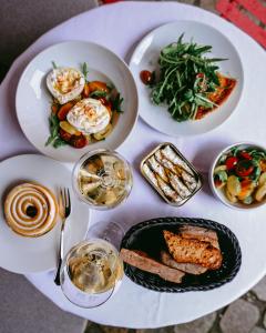 a white table with plates of food on it at TORTUE Hamburg in Hamburg