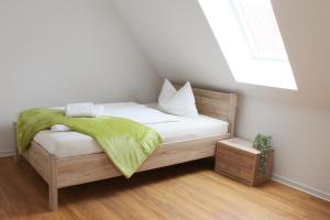 a small bedroom with a bed with a window at Hotel am Wittelsbacher Markt by greenpartment in Langquaid