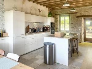 cocina grande con armarios blancos y encimera en Maison de 6 chambres avec jardin clos et wifi a Richarville, en Richarville