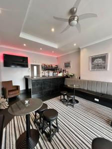 a lobby with a bar and tables and chairs at Tudor Rose Hotel in Blackpool