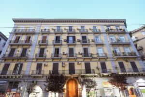um edifício alto com uma porta em frente em ENJOY Napoli - Exclusive Apartment em Nápoles
