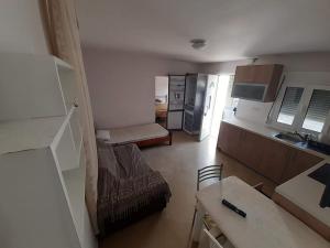a small room with a kitchen and a living room at Zorzet Village - Elounda in Kalidhón