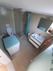 a small bathroom with a sink and a toilet at Zorzet Village - Elounda in Kalidhón