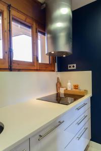 a kitchen with a sink and a stove at Flateli La Fosca in Palamós +25 photos