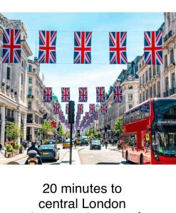 a red double decker bus on a street with british flags at Central locations 1 bed apartments sleeps 4 in London