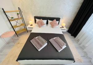 a bed with pillows on it in a room at Sara room in Curtea de Argeş