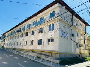 an old building on the side of a street at Sara room in Curtea de Argeş