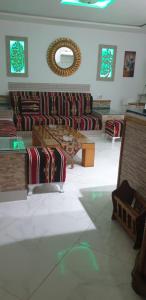a room with couches and a table and a mirror at Didon Manar in Tunis