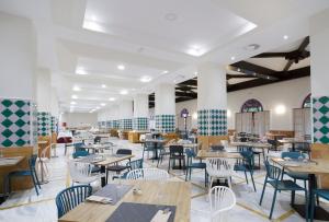 a dining room with tables and chairs in a building at Ibersol Almuñecar Beach & Spa Hotel in Almuñécar