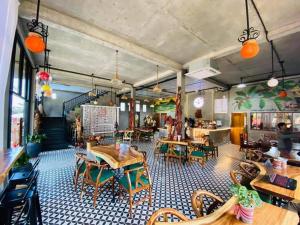 a restaurant with tables and chairs in a room at RaVorn Villa Boutique in Battambang