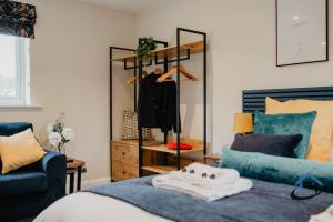 a bedroom with a mirror and a bed and a couch at Shambles Retreat - Nr Bath king or twin beds free parking x2 in Bradford on Avon