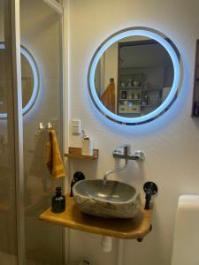 a bathroom with a sink and a mirror at Cozy Haven in Klaksvík