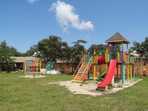 a playground with a colorful slide and a gazebo at Kampi Ya Boma Kolwezi in Kolwezi
